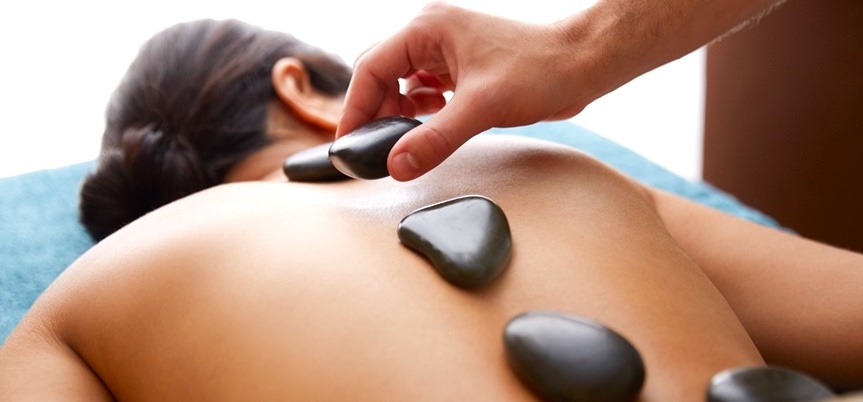 warm stones used to massage patient